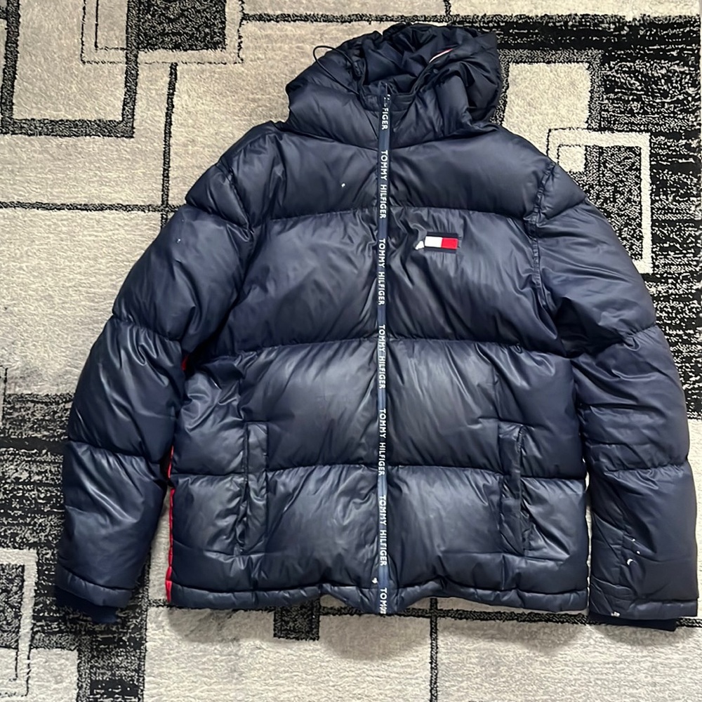 Tommy Hilfiger winter jacket with a couple tears.